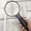 Magnifier Carson Split Handle HF-11 — 3.5× handheld magnifying glass, black/transparent, AAA battery