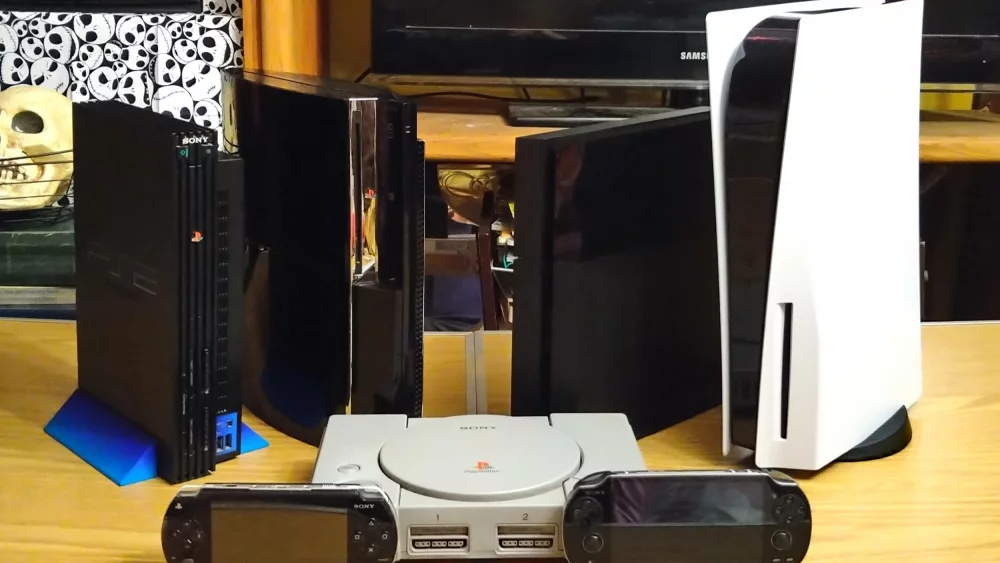 Collection of PlayStation consoles on a table